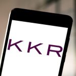 Smartphone with the KKR logo on the screen.