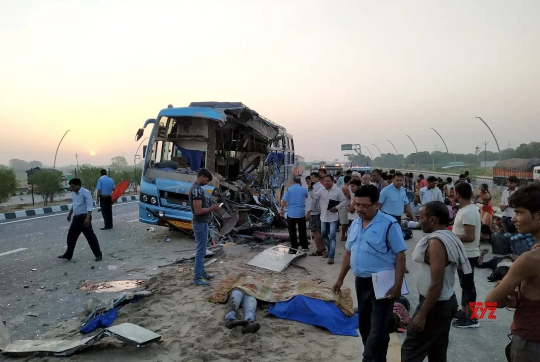 Overturned bus on the Lucknow-Agra Expressway after colliding with a vehicle. Emergency vehicles are at the scene.