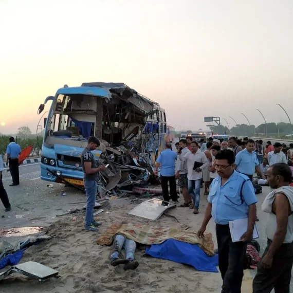 Overturned bus on the Lucknow-Agra Expressway after colliding with a vehicle. Emergency vehicles are at the scene.